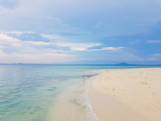 Sunshine on a sea wave at Karon beach, Phuket, Thailand. Sunny summer sea beach waves. Sunshine sea wave near sandy beach. Tropical island beach relax. Exotic landscape of ocean wave, Phuket island