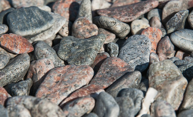 beach of multi-colored stones abstract background selective focus