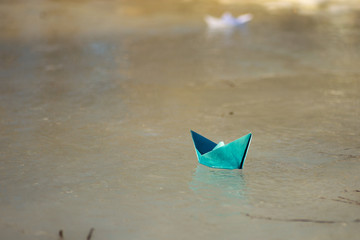Fototapeta na wymiar paper boat floats on the creek