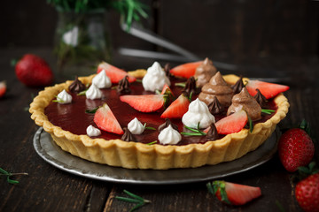 Vegan tart with chocolate and strawberry jelly