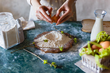 Close up view of baker kneading dough. Homemade bread. Hands preparing bread dough on wooden table. Woman hands kneading fresh dough for making bread.