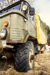 an army jeep with a rusty bumper and big wheels