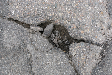 cracked whole in the asphalt road