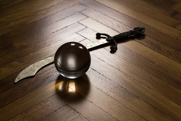 Crystal fortune-telling ball placed on wooden floor