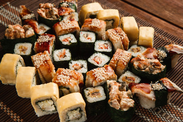 Fresh assortment of sushi, close up. Great roll set, japanese restaurant menu photo. Traditional seafood, food art.