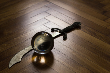 Crystal fortune-telling ball placed on wooden floor