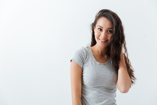 Portrait of happy beautiful young woman in grey t-shirt