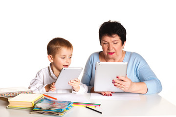 Grandmother with grandson learn and draw at table on a white background