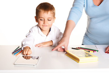 Grandmother with grandson learn and draw at table on a white background