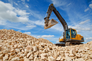 Excavator loads rock ore