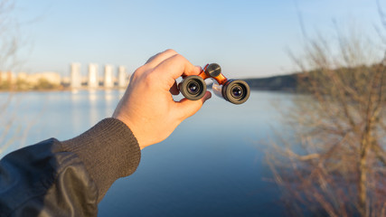 Hand holds binoculars