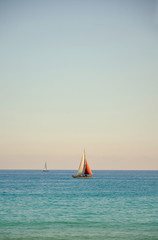 Lonely boat against the backdrop of the beautiful clear sea. Beautiful coast. An ideal place for rest and relaxation.