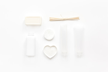 white cosmetic set on desk background top view