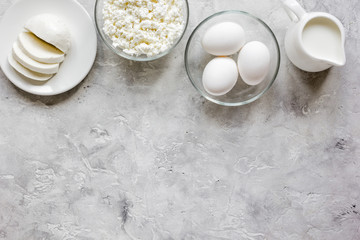 monochrome concept with dairy products on stone table top view mock up