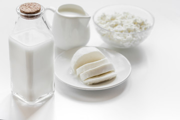 Healthy food concept with milk and cottage cheese on white table