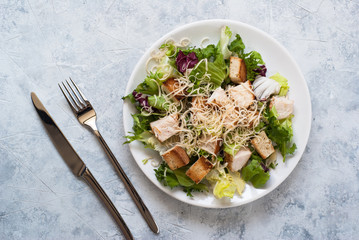 Caesar salad in white plate. Top view copy space.