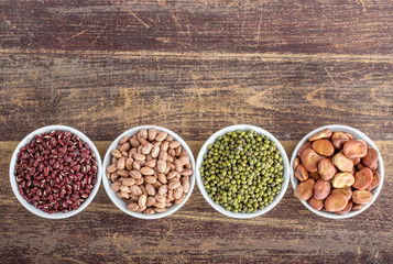 different legumes / Four porcelain nuts with different pod fruits