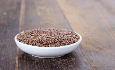 unpeeled linseed / Porcelain bowl with unpeeled linseed 