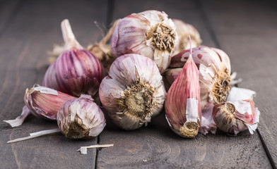 Organic garlic. Garlic press. Violet garlic.Wooden board.