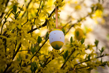 Decorated ornamental Easter eggs on a tree with flowers blossoms