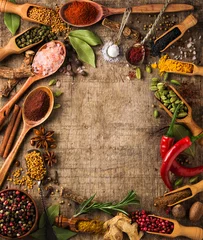 Gordijnen Herbs and spices on rough wood © andriigorulko