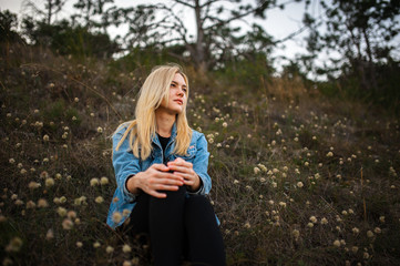 Young cute lady in jeans jacket outdoors portrait in abandoned place