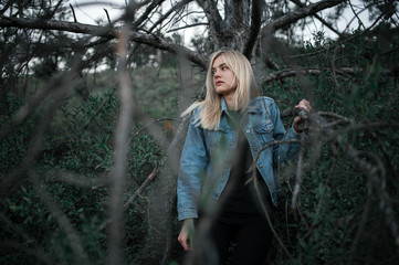Young cute lady in jeans jacket outdoors portrait in abandoned place