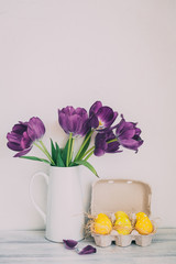 Fresh pink tulip flowers bouquet on shelf in front of stone wall. View with copy space