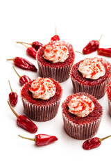 Chocolate  cupcakes with red hot chili pepper isolated on white