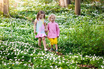 Children in spring park with flowers