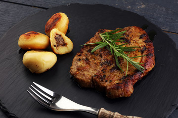 Grilled steaks, baked dumplings potatoes