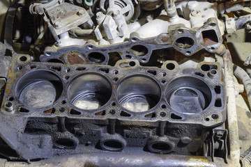 The cylinder block of the four-cylinder engine. Disassembled motor vehicle for repair. Parts in...