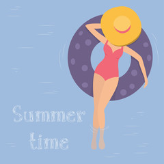 Woman in the hat floats in the pool on inflatable circles. The view from the top