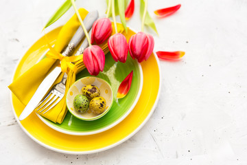 Spring table settings with fresh flower, napkin and silverware. Holidays background. 