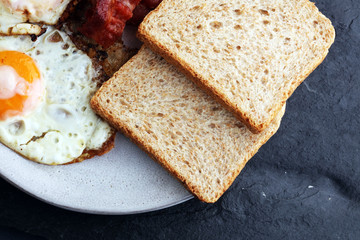 Ham and Egg. Bacon and Egg. Salted egg and sprinkled with black pepper. English breakfast.