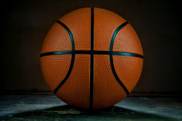 Basketball on the wood table and backlight.