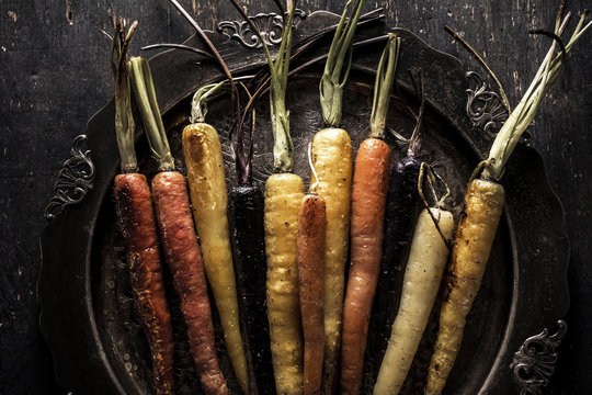 Roasted multicolored carrots om silver old fashioned platter