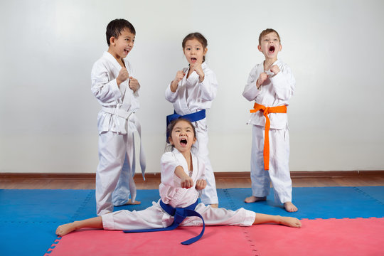 Four children demonstrate martial arts working together