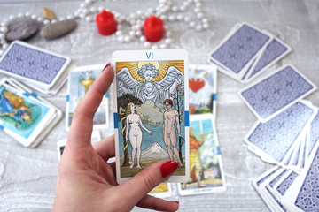 Tarot cards, candles and accessories on a wooden table