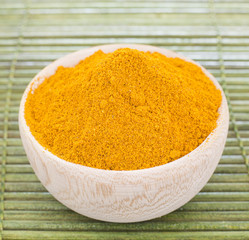 Turmeric powder in the wooden bowl (Curcuma longa)