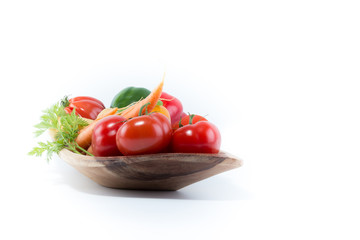 Fresh vegetables in a handmade natural real rectangular  wood bowl - tomatoes, carrots, pepper, potatoes