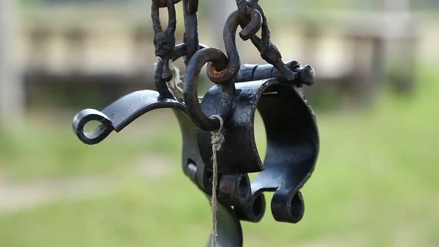 Ancient hammered fetters. Old black iron shackles. Iron forged gyves