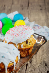 Beautiful Easter cakes, colorful eggs on wooden table on background