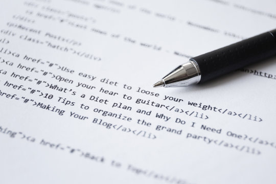 Script code on paper and pen, closeup. Software development concept