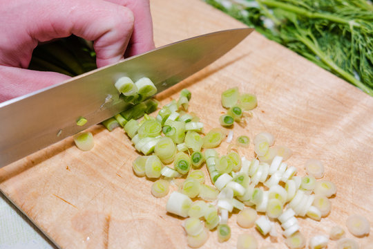 Greens for salad. Cut onions, fennel. Healthy food.