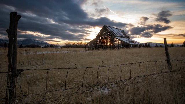 Time lapse of old barn at sunset