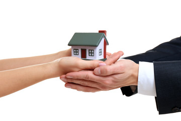 Naklejka premium People holding house model on white background