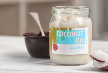 Fresh coconut oil in glassware on wooden  table