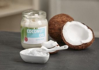 Fresh coconut oil and nuts on table