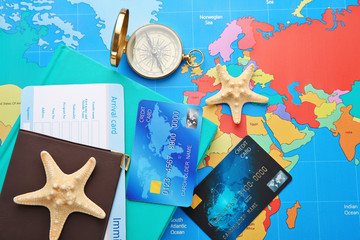 Credit cards with passport and ticket for vacations on world map background